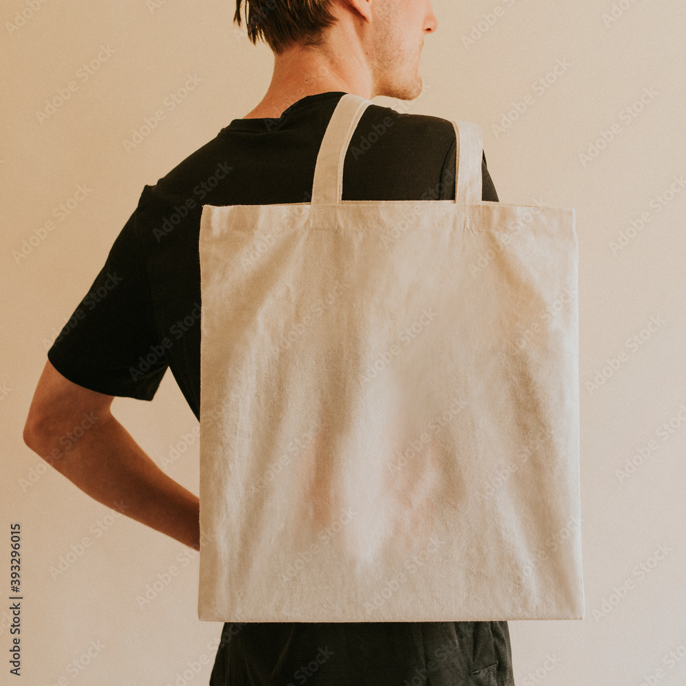 Back view man carrying tote bag Stock Photo | Adobe Stock