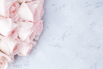 Delicate pink roses on light gray background close up, beautiful white flowers bouquet, birthday greeting card, valentines day, romantic design, floral corner border, wedding frame, text copy space
