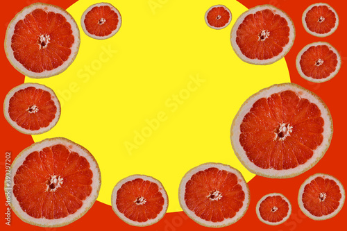 cut bright red halves grapefruit slices, circles of different sizes on colorful orange background with yellow round ellipse
