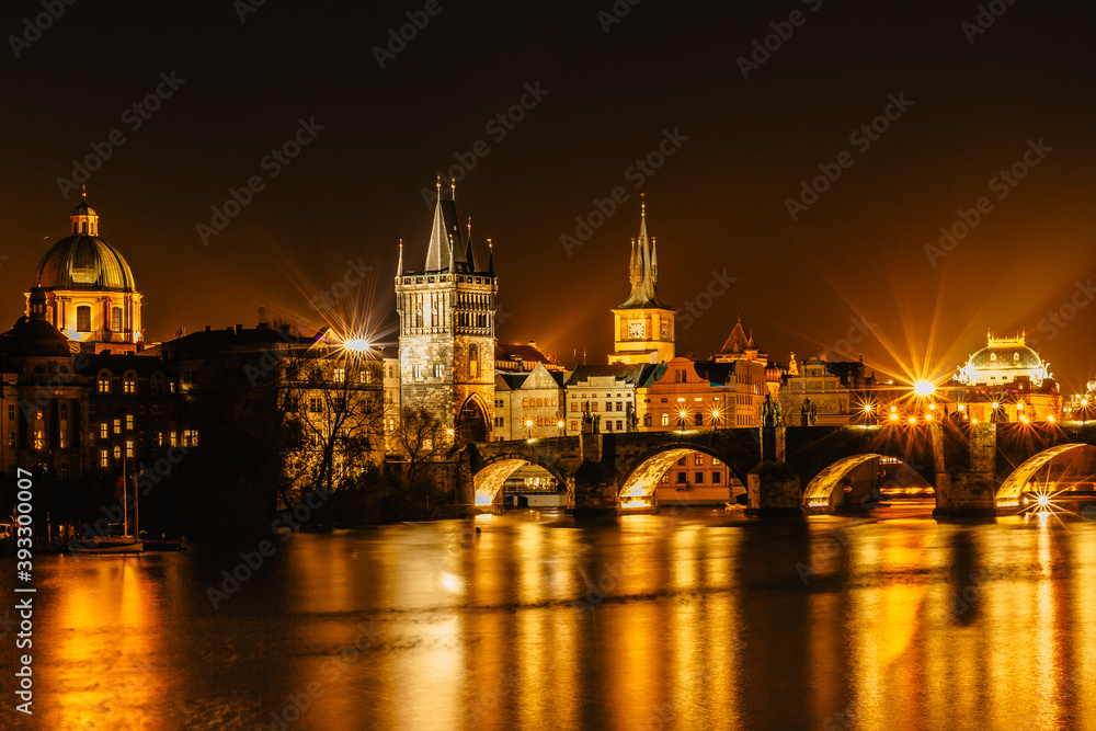 Illuminated Charles Bridge,Karluv most reflected in Vltava River. Evening panorama of Prague, Czech Republic. Long exposure city lights.Amazing European cityscape.Travel urban concept