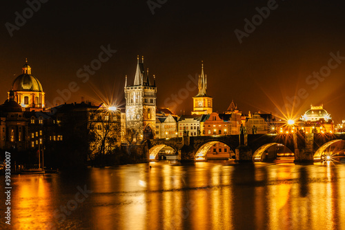 Illuminated Charles Bridge,Karluv most reflected in Vltava River. Evening panorama of Prague, Czech Republic. Long exposure city lights.Amazing European cityscape.Travel urban concept