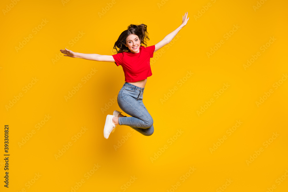 Full size photo of cheerful girl jump hold hand isolated over vivid color background
