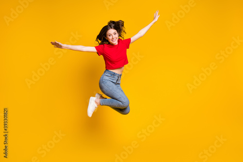 Full size photo of cheerful girl jump hold hand isolated over vivid color background