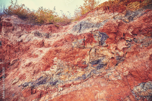Texture of steep clay bank. Nature landscape