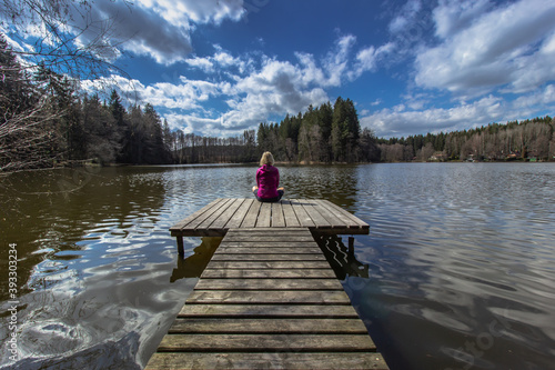 Obraz na płótnie Beautiful young girl meditating by lake. Practicing yoga outdoors. Harmony and meditation concept.Healthy lifestyle. Woman feeling freedom and enjoying the nature.Workout in nature.Anti-stress therapy w salonie