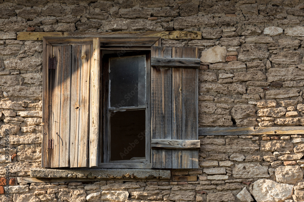 Old house and broken window with wooden lid
