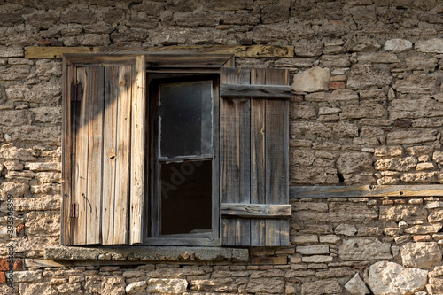 Old house and broken window with wooden lid