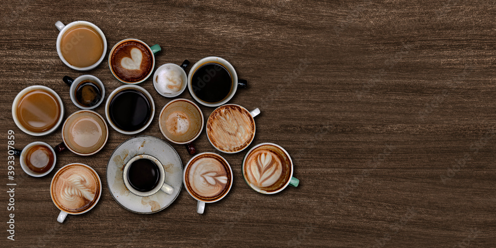 Mixed coffee cups on a walnut wooden textured background Mixed coffee cups on a walnut wooden textured background
