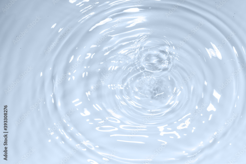 Water drop on clear water wave circle pattern background Water drop on clear water wave circle pattern background