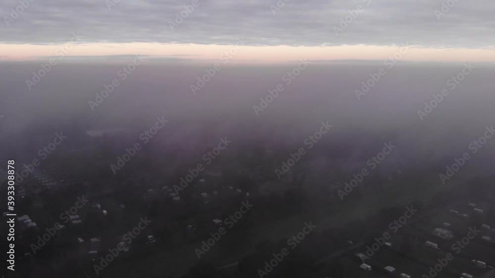 Pan drone shot above the clouds on a campsite on a lake in the Flevoland polder in the netherlands Pan drone shot above the clouds on a campsite on a lake in the Flevoland polder in the netherlands