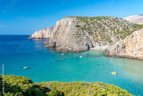 overview of Cala Domestica with crystal clear water and Mediterranean vegetation, Sardinia