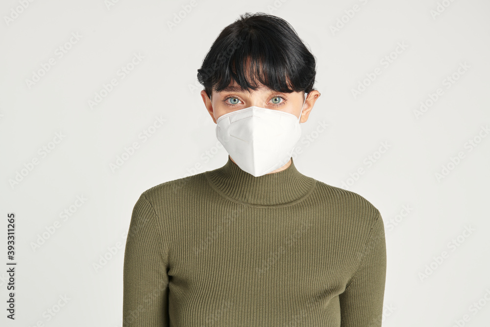 Face mask mockup on a women in a green turtleneck top Face mask mockup on a women in a green turtleneck top