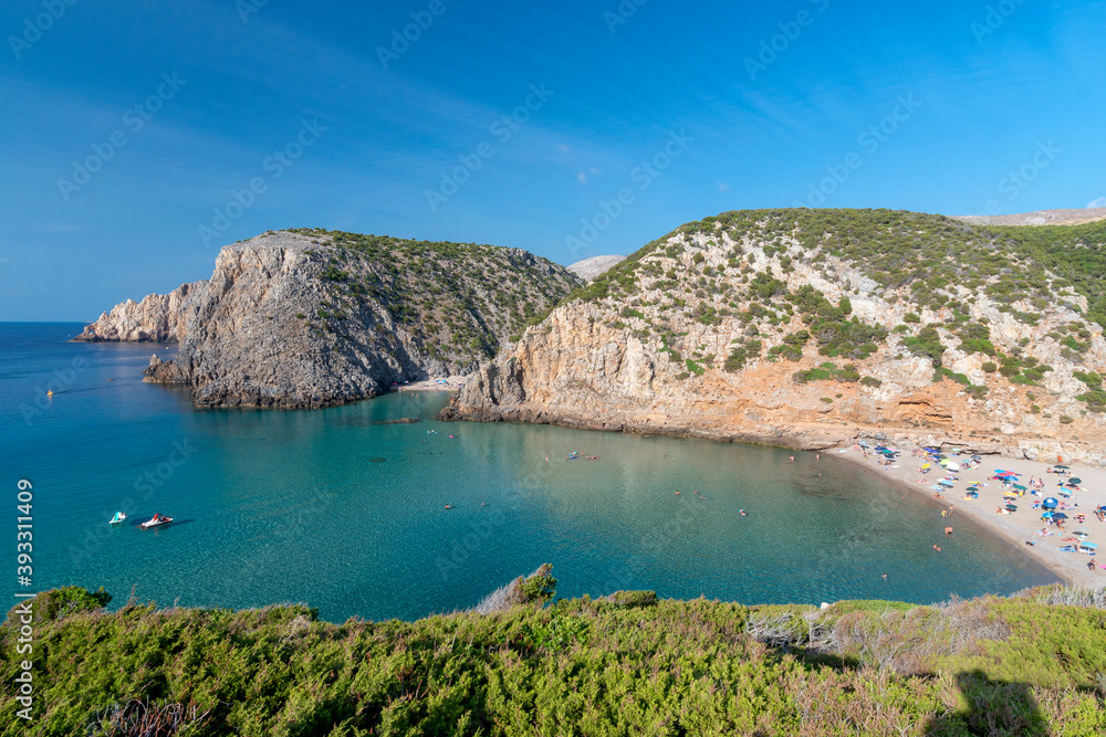 overview of Cala Domestica with crystal clear water and Mediterranean vegetation, Sardinia