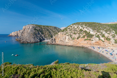 overview of Cala Domestica with crystal clear water and Mediterranean vegetation, Sardinia
