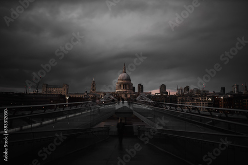 Photography Millennium Bridge with the St Paul Cathedral in the distance below cloudy sky