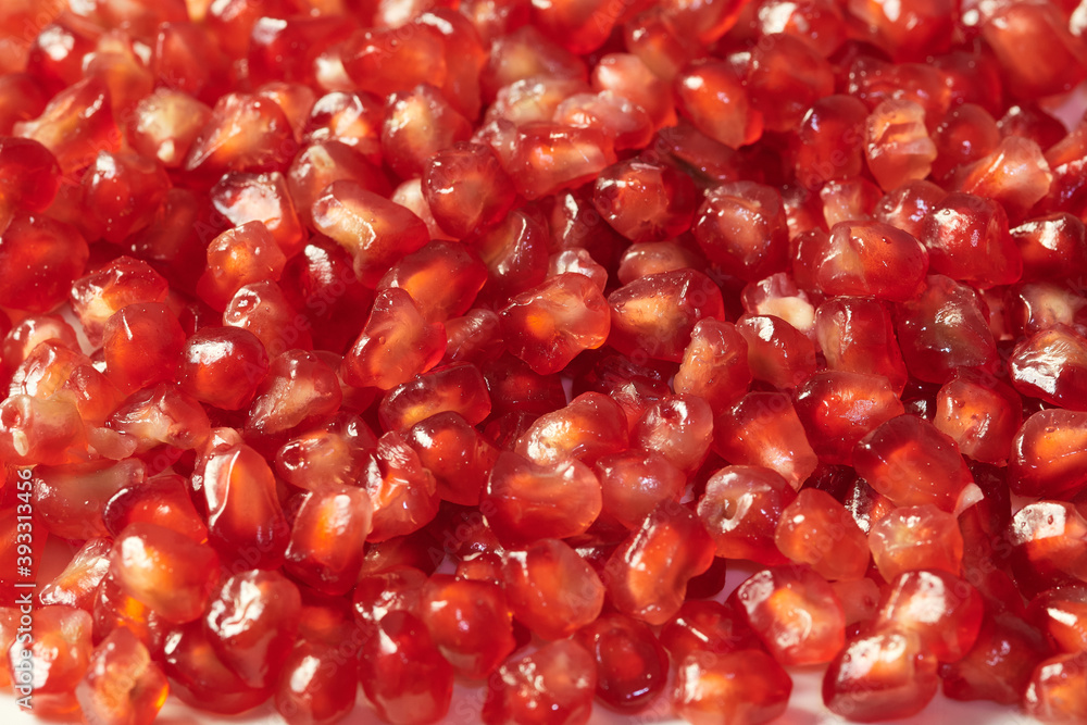texture of red seeds of the pomegranate fruit prepared on a plate ready to eat. pomegranate seed background texture of red seeds of the pomegranate fruit prepared on a plate ready to eat. pomegranate seed background