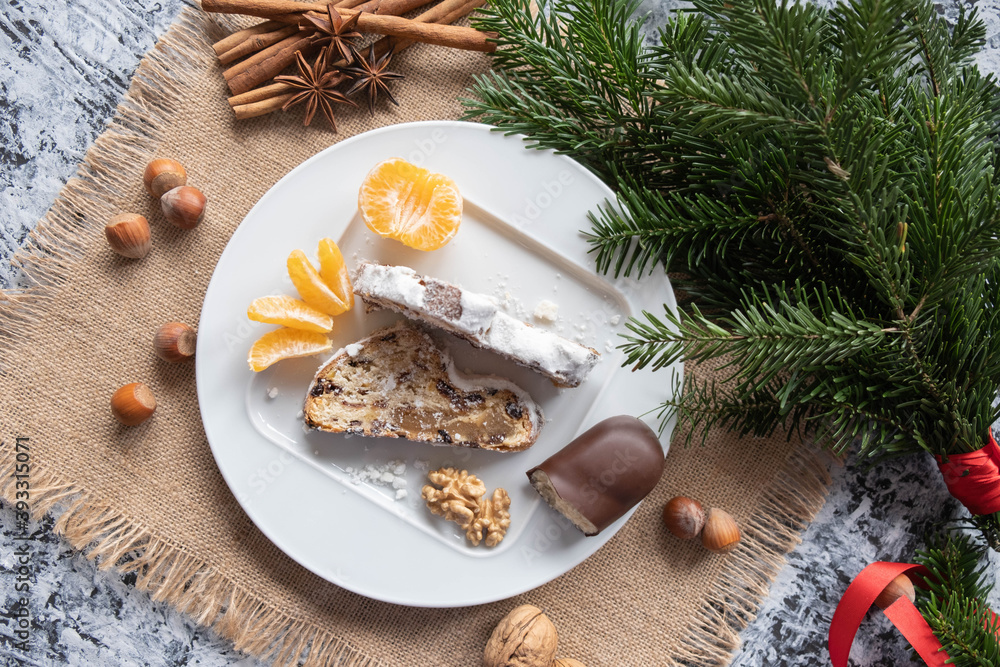 Christmas decoration, two slices of Christmas cake with marzipan, nuts and raisins, tangerine, walnut and marzipan Christmas decoration, two slices of Christmas cake with marzipan, nuts and raisins, tangerine, walnut and marzipan