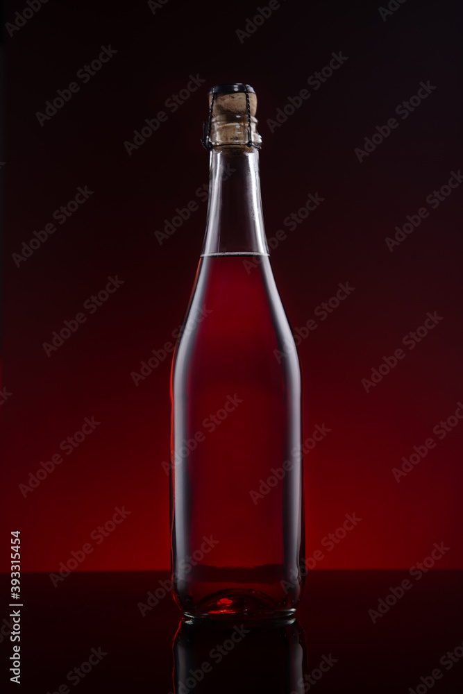 Bottle of Lambrusco wine on red dark background. Bottle of Lambrusco wine on red dark background.