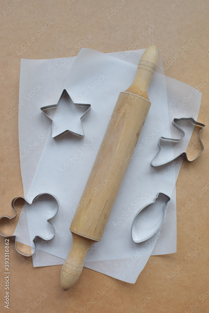 Molds for baking cookies, gingerbread lie on a wooden background. Molds for baking cookies, gingerbread lie on a wooden background.