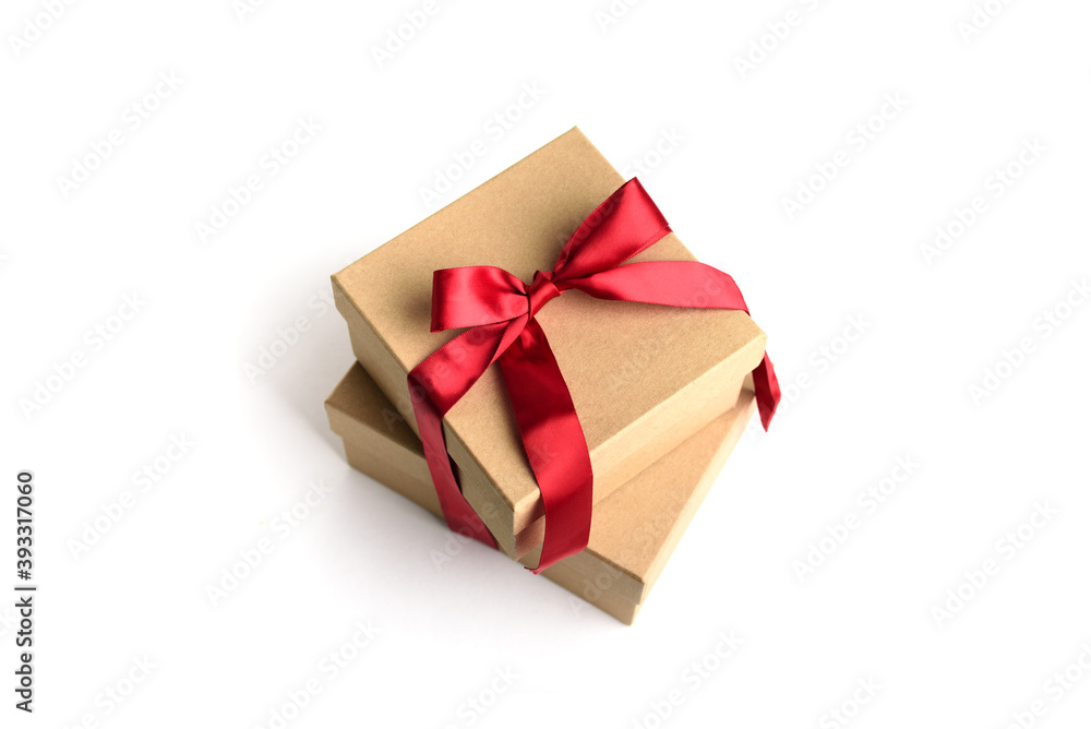 Two craft gift boxes with red ribbon bow isolated on white background. Two craft gift boxes with red ribbon bow isolated on white background.