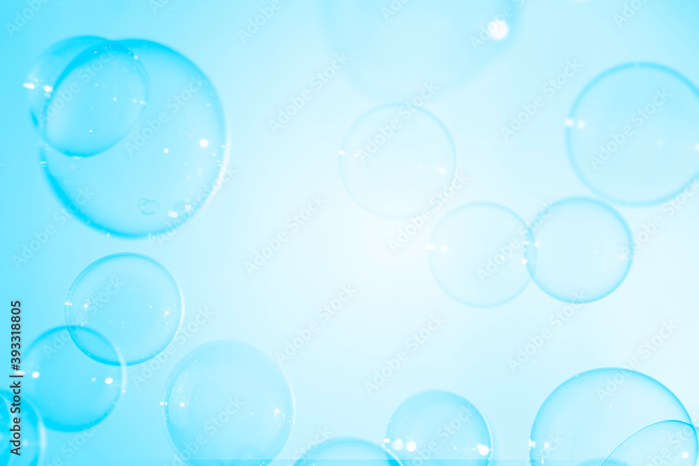 Abstract, transparent blue soap bubbles floating with copy space. Natural freshness summer holiday background.