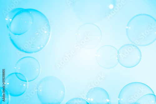 Abstract  transparent blue soap bubbles floating with copy space. Natural freshness summer holiday background.