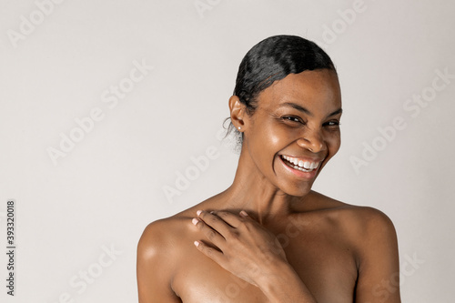 Cheerful bare chested black woman portrait