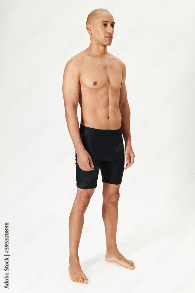 Fototapeta premium Man in black swmming jammers full body shot