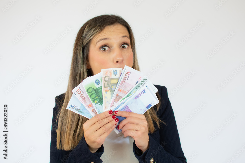Close up portrait of a exciting young business woman holding money banknotes and celebrating isolated over white background Close up portrait of a exciting young business woman holding money banknotes and celebrating isolated over white background