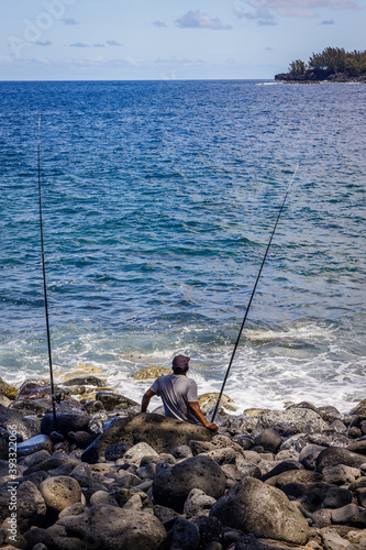Angler fishing in Anse des Cascades bay in Sainte-Rose on Reunion Island