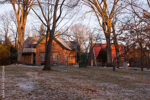 The 1849 protestant Mount Hermon Cemetery red brick gothic revival entrance lodge with the 1854 St. Michael Church in the background, Quebec City, Quebec, Canada