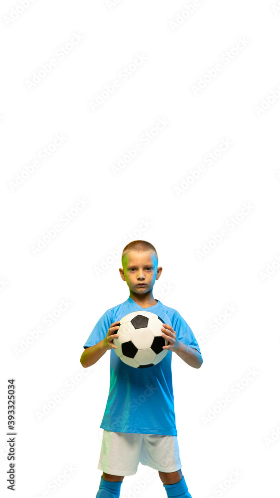 Young boy with soccer ball isolated on white studio background, vertical flyer with copyspace for social media, advertising, offers. Junior football, soccer player. Childhood, sport, action concept. Young boy with soccer ball isolated on white studio background, vertical flyer with copyspace for social media, advertising, offers. Junior football, soccer player. Childhood, sport, action concept.