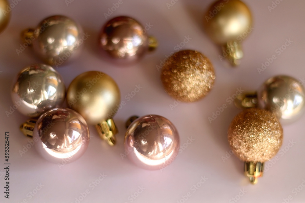 Christmas baubles in gold and pink tones. Selective focus, pink background.