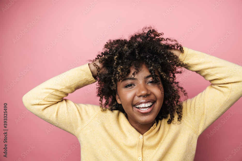 Joyful african american woman smiling and making fun with her hair Joyful african american woman smiling and making fun with her hair