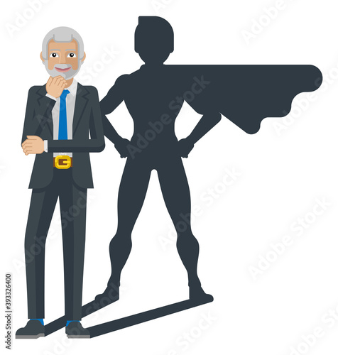 A mature business man revealed as super hero by his superhero silhouette shadow