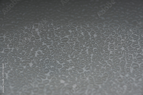 rough grainy textured background with shades of gray as a liquid on a metal surface in black and white backdrop