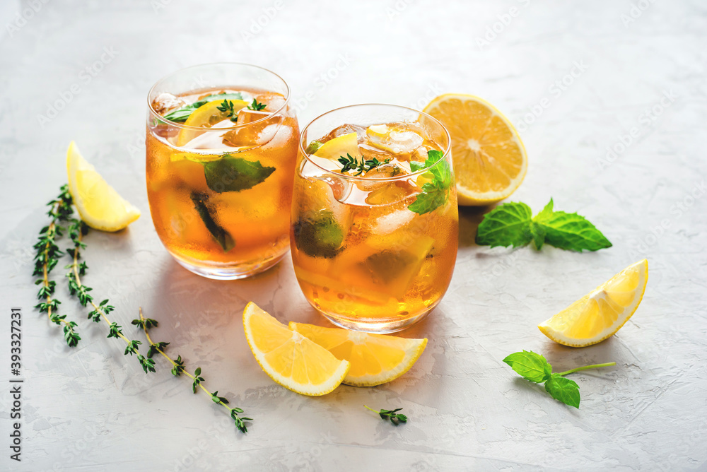 Fototapeta premium Iced tea with ice, mint and lemon. Refreshment cold summer drink.