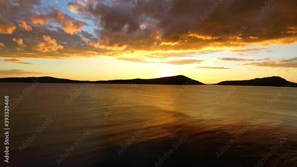 Aerial view of Pylos bay, Peloponnese, Greece, at golden dusk with clouds lit by the setting sun. Aerial view of Pylos bay, Peloponnese, Greece, at golden dusk with clouds lit by the setting sun.