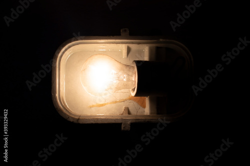 Loft industrial stylized lamp / reflector/ headlight / spotlight hanging on the dirty wall in the basement / magazine photo