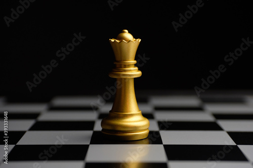 Gilded chess piece queen on the board