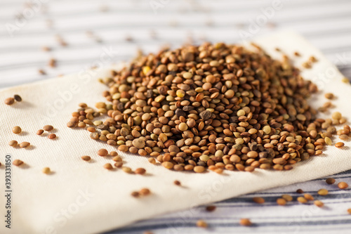 Detail photo of lot of brown lentils in natural light. Selective focus - very shallow depth of field. © Stockis