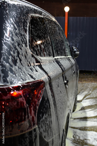 Gray car in foam. Car wash. The concept of a pure car