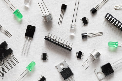 Microcontrollers, transistors, green LEDs, microcircuits, thyristors on a white background. Radio Components photo