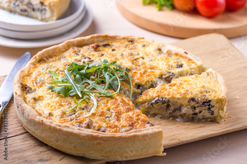 Traditional French Quiche with cheese  spinach and chicken. Quiche lorraine. French cuisine. Top view. Light wooden background