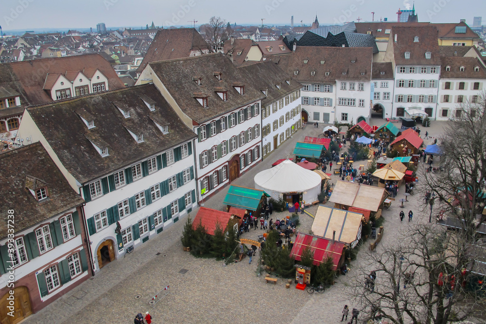 Fototapeta premium Aerial view of main square,Munsterplatz with famous Christmas markets in Basel,Switzerland. Beautiful European cityscape.X-mas decoration.People from above strolling on the market.Swiss architecture.