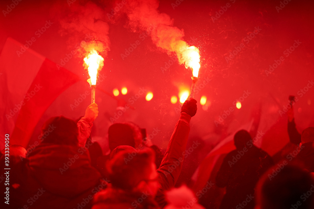 flaming red flare during a street protest in the city