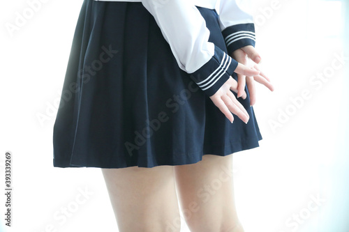 part of japanese school girl legs in white tone bed room