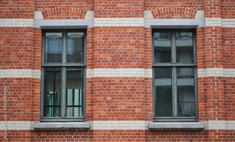 the windows of a brick building the windows of a brick building