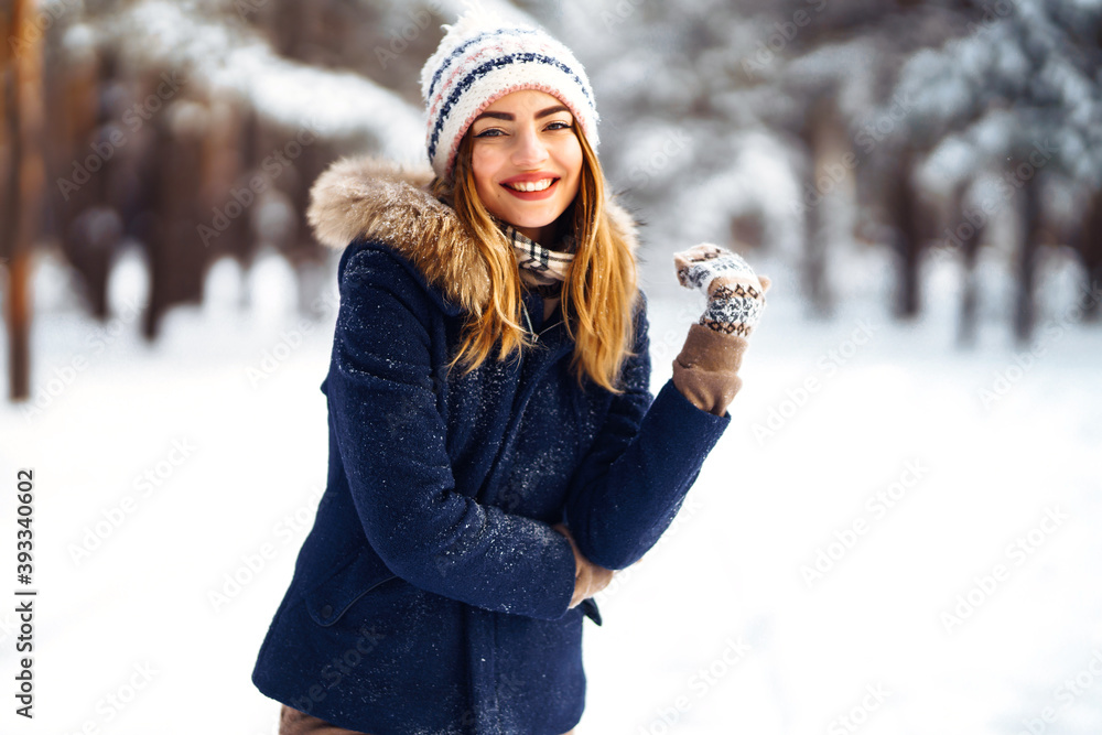 Portrait of Beautiful woman enjoys winter, frosty day. Fashion young woman in the snow forest. Winter holidays. Portrait of Beautiful woman enjoys winter, frosty day. Fashion young woman in the snow forest. Winter holidays.