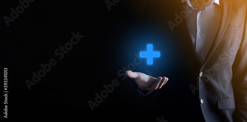 Businessman, man hold in hand offer positive thing such as profit, benefits, development, CSR represented by plus sign.The hand shows the plus sign